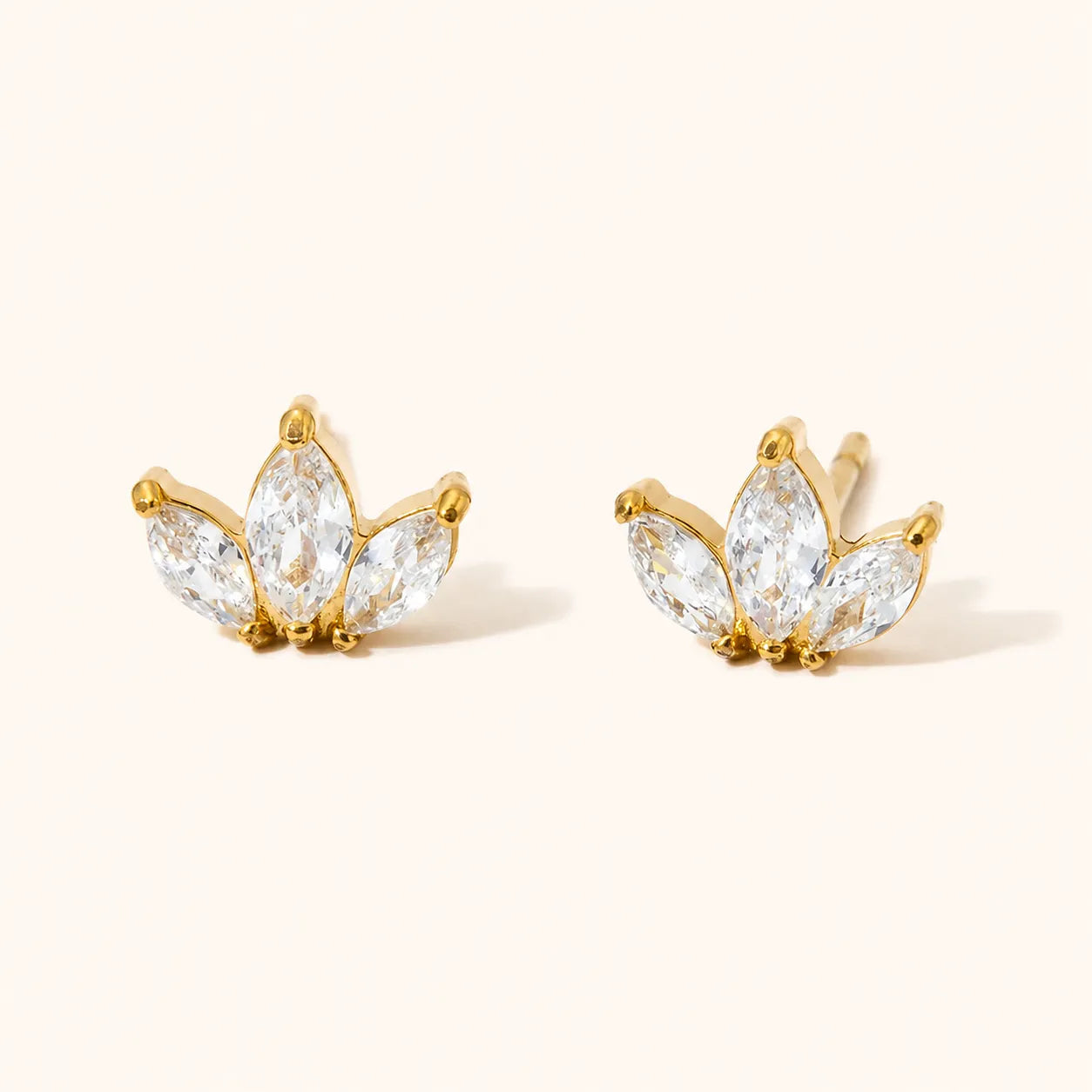 Three-stone marquise clear stud earrings in a lotus-inspired shape, available in 18k gold